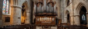 a stunning view of a medieval stone church interior, featuring a grand pipe organ as the focal point. the elegant wooden pews, gothic arches, and beautiful stained glass windows add to the majestic and serene atmosphere. ai generated image.